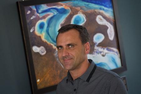 Photographer Filip Kulisev with one of his works, the Element.
