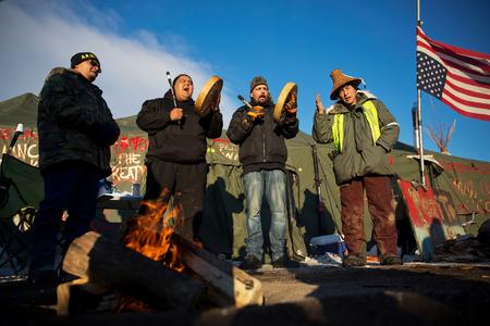 Native Americans drum and sing at the Oceti Sakowin camp where people have gathered to protest the Dakota Access oil pipeline in Cannon Ball on December 4, 2016.