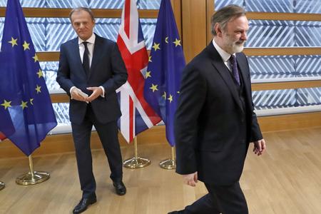 Britain's permanent representative to the European Union Tim Barrow (right) leaves after he delivered the Brexit letter to EU Council President Donald Tusk in Brussels.