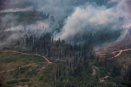 A wildfire burns near the Nadleh Whut'en First Nation in Fort Fraser, British Columbia, Thursday, Aug. 23, 2018. 