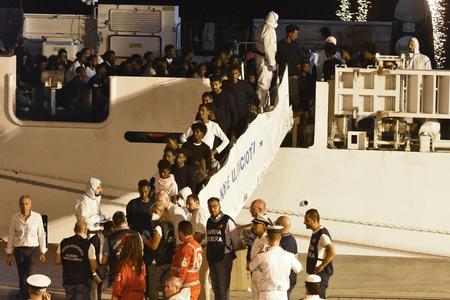 Passengers disembark from the Diciotti ship in Sicily. 