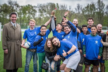 The winning team Sendrejovci - Plavecký štvrtok receives the trophy from US Ambassador Adam Sterling (L) during the Roma against diplomat tournament on April 8.