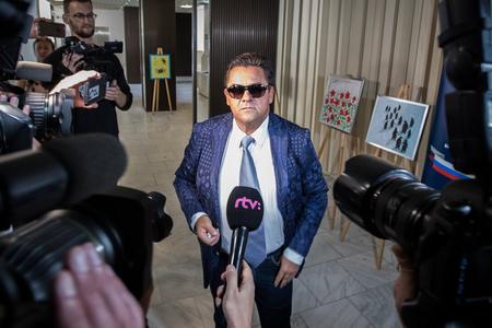 Kočner in a blue jacket and sunglasses.