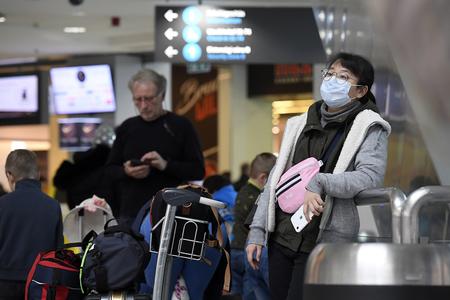 A passenger wears a face mask at Ferenc Liszt International Airport in Budapest, Hungary, on February 4, 2020. 