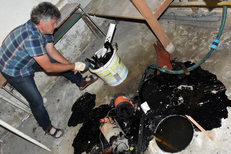 Expert taking sample of the leak. 