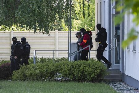 Police escorts Alena Zsuzsová from the courtroom.