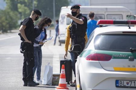 The police speak with a driver on the Bratislava-Berg border crossing on May 17, 2020. 