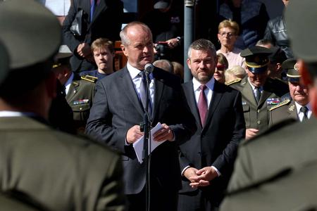 Defence Minister Peter Gajdoš (foreground) and PM Peter Pellegrini attend a ceremony together