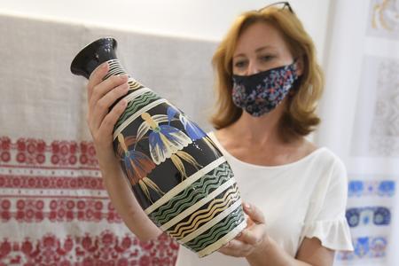 Director of the ÚĽUV regional craft centre in Košice, Júlia Jeleňová, with Pozdišovce ceramics.