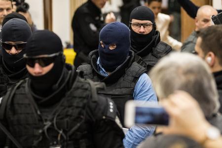 Zoltán Andruskó is escorted to the courtroom.