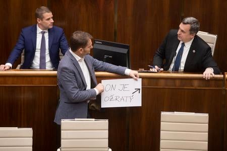 OĽaNO chair Igor Matovič (centre) is holding a banner saying "He is drunk", referring to Speaker of Parliament Andrej Danko (r).