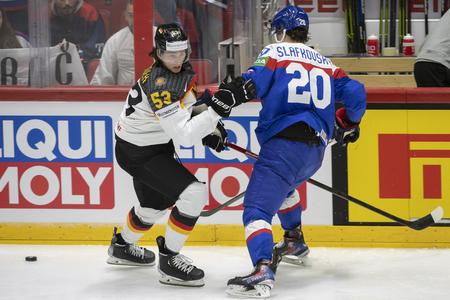 Slovak player Juraj Slafkovský and German player Moritz Seider are fighting for the puck at the world hockey championship in Finland on May 14, 2022.