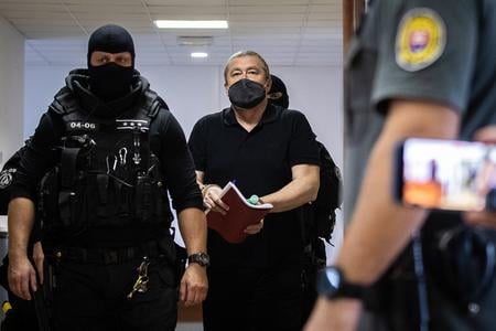 Former special prosecutor Dušan Kováčik escorted to the courtroom on September 20.