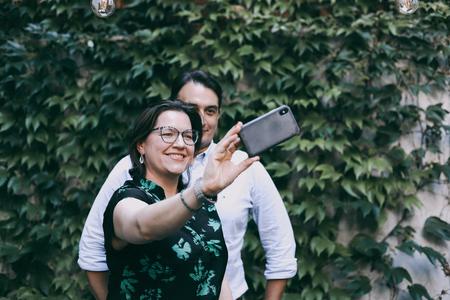 Canadian-Icelandic writer and Iceland's First Lady Eliza Reid takes a selfie with Slovak President Zuzana Čaputová's spouse Juraj Rizman in Bratislava on July 15, 2022.