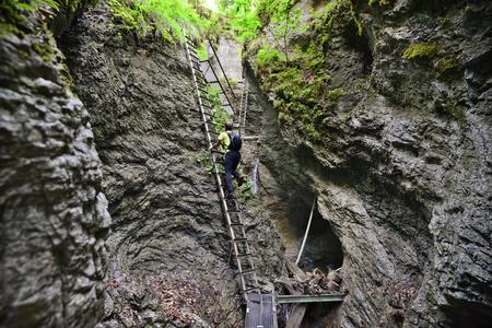 A hiker climbs a ladder at the Misové Waterfalls in the Suchá Belá gorge in Slovak Paradise National Park, eastern Slovakia.