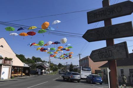 Umbrellas are installed up in the air and above the main road in Trstené pri Hornáde near Košice.
