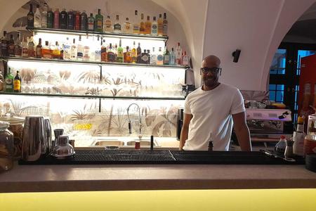 Asiel Caro stands behind the counter inside the RU!DO queer club.