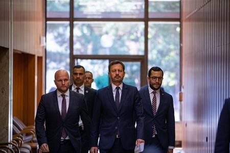 Prime Minister Eduard Heger (centre) and Defence Minister Jaroslav Naď (left) arrive at a government meeting on August 31, 2022, in Bratislava. 