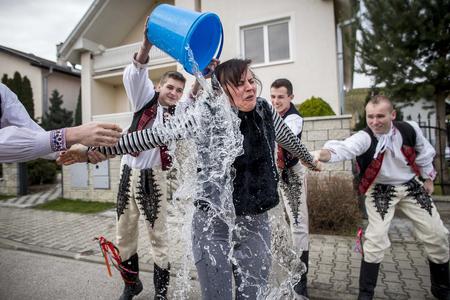 Traditional Slovak "oblievačka" - men bathe women in water for good health and beauty.