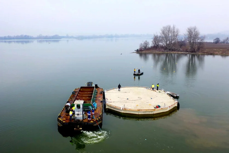 A vessel towing the floating island to the centre of the Sĺňava reservoir near Piešťany, west Slovakia.