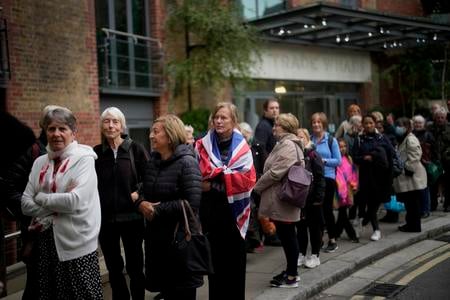 People queue to pay their final respects to Queen Elizabeth II during the Lying-in-State at Westminster Hall in London on Friday, September 16, 2022.