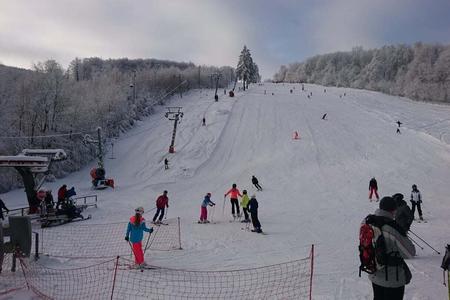 Skiers on the slope next to the Double ski lift in the ski resort Pezinská Baba on December 11, 2021.