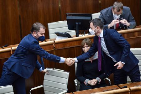Finance Minister Igor Matovič and PM Eduard Heger shaking hands after parliament passed state budget for next year.