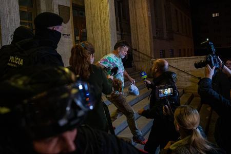 Dušan Dědeček runs from journalists in front of the courthouse. The judge decided he would be prosecuted at large. 