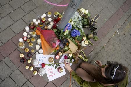 Candles and flowers are placed at the site of Wednesday's attack on Zámocká Street on Thursday, October 13. 