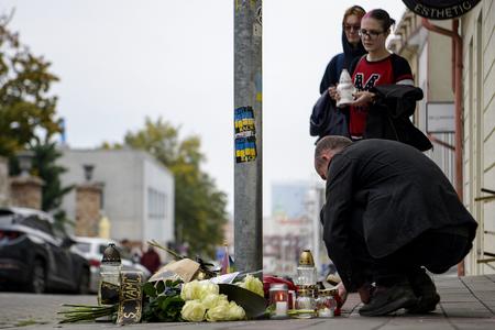 People light candles outside Tepláreň Bar in Bratislava on October 13, 2022. 