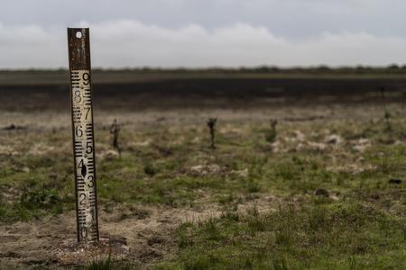 A water metre stands in a dry wetland in Donana natural park, southwest Spain, on October 19, 2022.