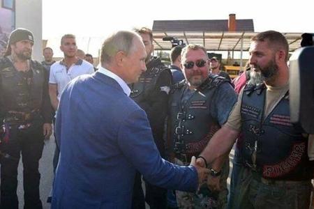 Jozef Hambálek (on the right) shaking hands with Vladimir Putin. In the background (on the left with a hat on) is the head of Russian Night Wolves Alexander Zaldostanov.