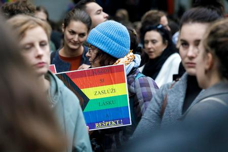A protest goer holds an "Everyone deserves love and respect" banner during a gathering in Bratislava on October 27, 2022.