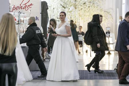 A model shows off a wedding dress during a wedding fair.