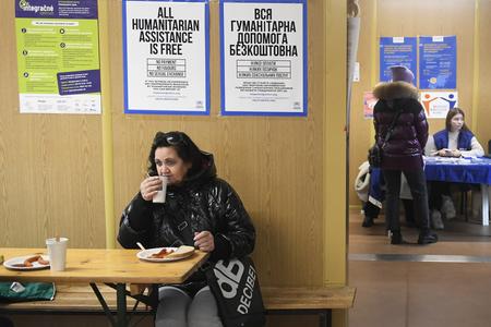 A woman eats her meal at the Aid Centre for Ukrainian Refugees in Košice on November 28, 2022. Refugees come to the centre in larger numbers during this period, also because of the cold weather and the energy crisis. They receive food and temporary accommodation here.