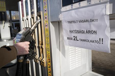 A view of a sign on a fuel pump at a petrol station reading 'Dear Costumers! You can purchase only 2 litres of fuel at the regulated price!' in Martonvasar, Hungary, on December 1, 2022.