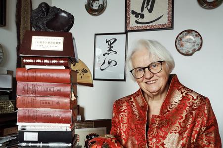 Marina Čarnogurská sitting next to the pile of her published works.