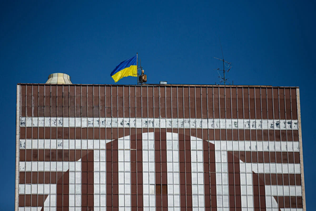 Ukrainian flag waves atop Bratislava's Hotel Kyjev, but refugees cannot stay there