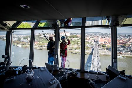 Wearing red overalls, adrenaline junkies can skywalk around Bratislava's UFO