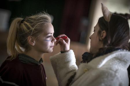 Kids help each other to get ready for the Fašiangy Carnival.