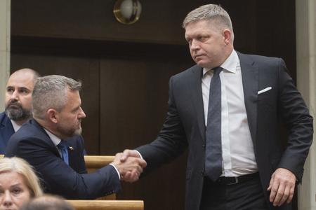 Robert Fico shook hands with his rival, Peter Pellegrini, and with the far right MPs after the vote. 