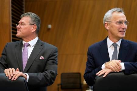 NATO Secretary General Jens Stoltenberg, right, and European Commissioner for Inter-institutional Relations and Foresight Maroš Šefčovič wait for the start of a meeting of the College of Commissioners at EU headquarters in Brussels on November 15, 2023.