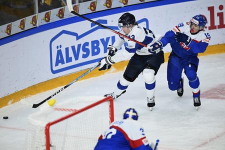 Finland's Jani Nyman, right, and Slovakia's Juraj Pekarčík, left, challenge for the puck during the in IIHF World Junior Championship ice hockey quarter final match between Slovakia and Finland at Froelundaborg in Gothenburg, Sweden, on January 2, 2024.