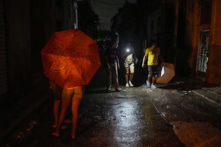 People walk down the street during a power outage caused by Hurricane Oscar in Havana, Cuba, on October 20, 2024. Cuba has been experiencing widespread power outages since Friday, October 18, 2024.