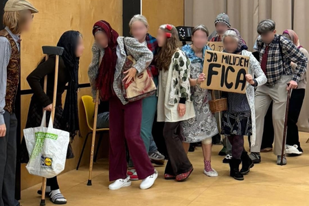 Students at Bílikova Gymnázium in Bratislava dress as pensioners, holding a sign reading "I love Fico" on October 31, 2024.