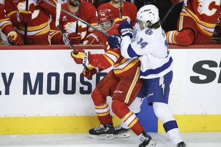 Conor Geekie (right) and Slovak forward Martin Pospíšil of the Calgary Flames tussle during an NHL game between the Flames and the Tampa Bay Lightning in Calgary on 12 December 2024.