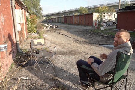 Miro Tolla of the punk band Nihilobstat, who practiced in the Prístavný most garages in the early 1990s, about to be interviewed outside the same garages by budding documentarian Tomáš Bulánek .