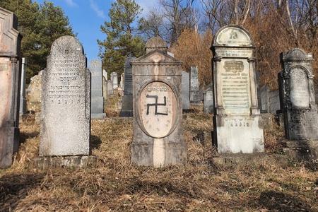 Gravestones in Humenné's Jewish Cemetery, including one that has been defaced with a Nazi symbol.
