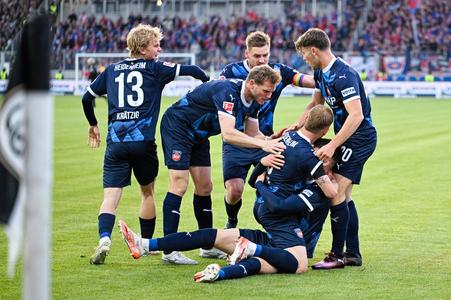 Hráč Heidenheimu Mathias Honsak sa raduje z gólu so spoluhráčmi počas odvetného barážového zápasu o účasť v Bundeslige SV Elversberg - 1. FC Heidenheim.