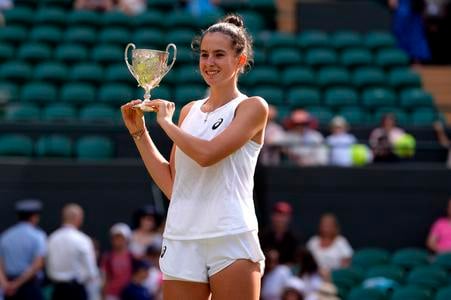 Mia Pohánková celebrates with the trophy after beating Julieta Pareja of the U.S. to win the final of the girls singles at the Wimbledon Tennis Championships in London, Saturday, 12 July 2025.